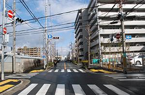 交差点の先にマンションが立ち並ぶ今の写真