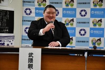 武隈親方がマイクを持って話をしている写真
