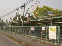 金網で柵がしてある京阪寝屋川市駅 駅西自転車駐車場を道路側から撮影した写真