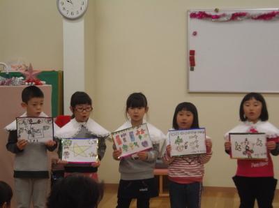 それぞれの園児が描いた絵をもって立っている5人の子供たちの写真